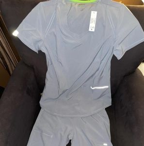 Grey with lime green seams Scrubs size small. V neck, cargo pockets in pants.